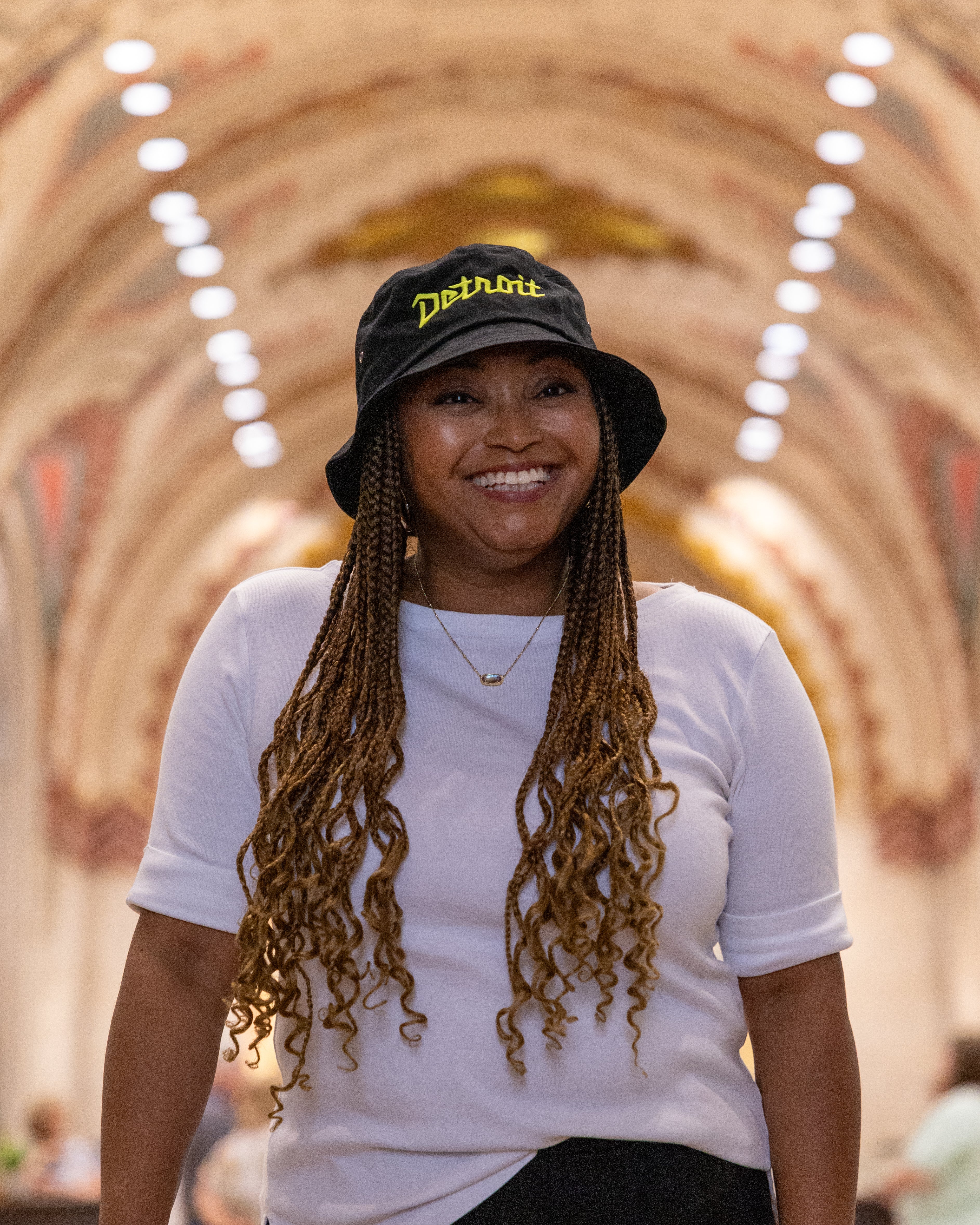 Women wearing black and yellow Detroit bucket hat 