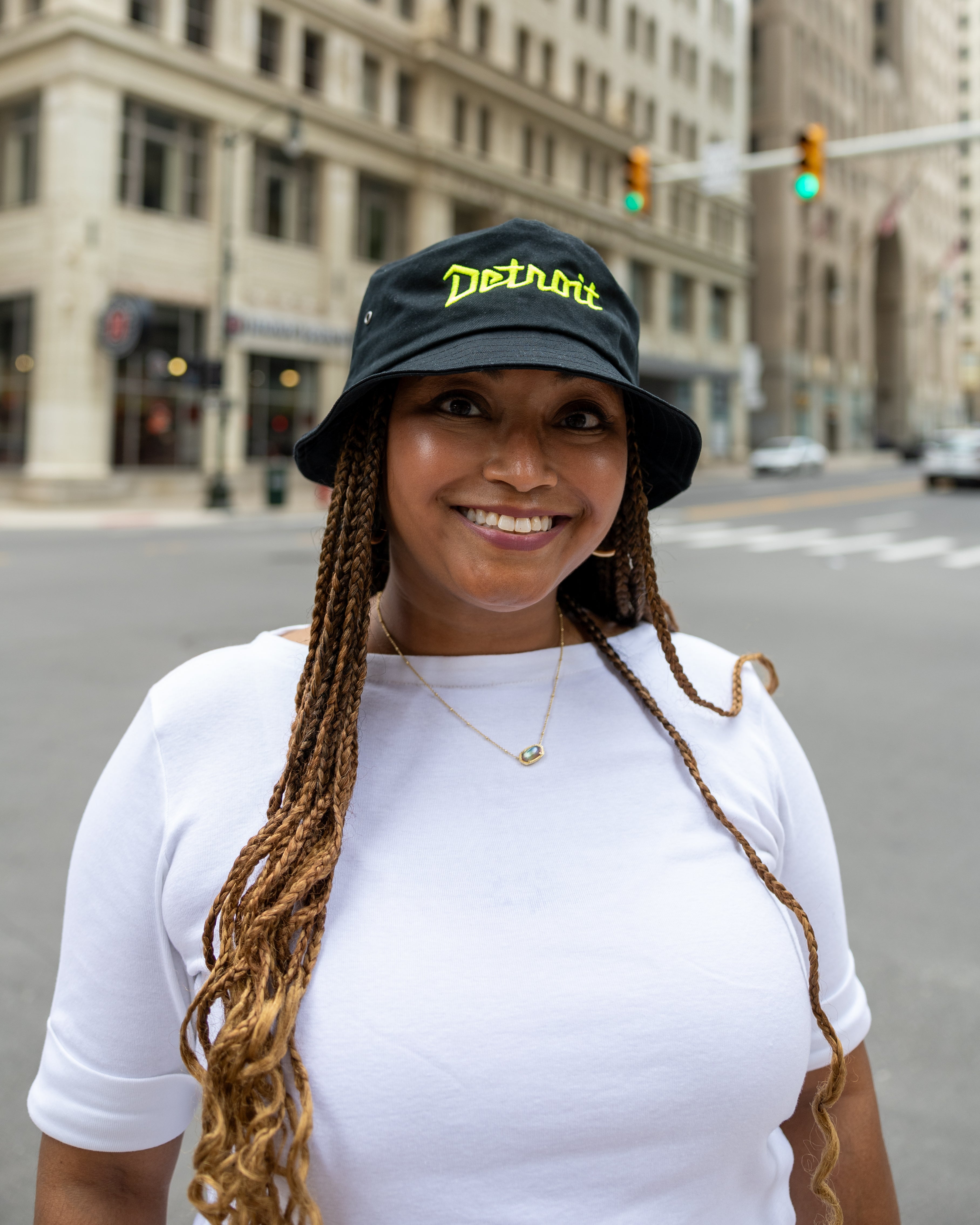 Women wearing black and yellow Detroit bucket hat 