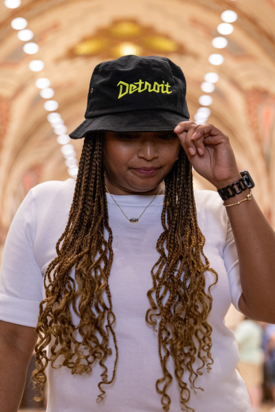 Women wearing black and yellow Detroit bucket hat 